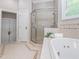 Elegant bathroom with a glass-enclosed shower and a soaking tub, designed for relaxation and comfort at 540 Vista Del Lago Ln, Wake Forest, NC 27587