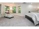 Cozy bedroom featuring a comfortable seating area, large windows, and soft carpeting at 540 Vista Del Lago Ln, Wake Forest, NC 27587
