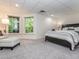 Comfortable bedroom featuring a seating area, large windows, and soft carpeting at 540 Vista Del Lago Ln, Wake Forest, NC 27587