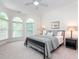 Bedroom featuring a large bed, neutral walls, and a bank of arched windows at 540 Vista Del Lago Ln, Wake Forest, NC 27587
