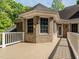 Inviting deck with brick facade, wooden floors, and white railing, perfect for outdoor relaxation and entertaining at 540 Vista Del Lago Ln, Wake Forest, NC 27587