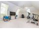 Large exercise room under the eaves with workout equipment and a ceiling fan at 540 Vista Del Lago Ln, Wake Forest, NC 27587