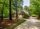 Brick home with lush landscaping and a winding driveway, creating a serene, private setting at 540 Vista Del Lago Ln, Wake Forest, NC 27587
