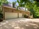 Charming brick home with three car garage and well maintained yard on a sunny day at 540 Vista Del Lago Ln, Wake Forest, NC 27587