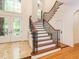 Elegant foyer with a curved staircase, tile flooring, and a grand front entrance with decorative glass at 540 Vista Del Lago Ln, Wake Forest, NC 27587
