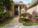 Elegant brick home with arched entryway, double doors, and meticulously maintained landscaping at 540 Vista Del Lago Ln, Wake Forest, NC 27587