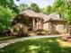 Stately brick home boasts mature landscaping, manicured lawn, and inviting front entrance at 540 Vista Del Lago Ln, Wake Forest, NC 27587