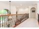 Upstairs hallway with iron railing and arched windows and doorways at 540 Vista Del Lago Ln, Wake Forest, NC 27587