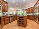 Expansive kitchen featuring a large island, stainless steel appliances, custom cabinetry, and wood floors at 540 Vista Del Lago Ln, Wake Forest, NC 27587