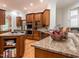 Gourmet kitchen with granite countertops, stainless steel appliances, custom cabinets, and center island at 540 Vista Del Lago Ln, Wake Forest, NC 27587