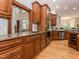 Gourmet kitchen showcasing custom wood cabinetry, granite countertops, and stainless steel appliances with wood flooring at 540 Vista Del Lago Ln, Wake Forest, NC 27587