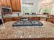 Kitchen island with granite countertop and gas cooktop, wood cabinets, and stainless steel appliances at 540 Vista Del Lago Ln, Wake Forest, NC 27587