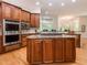 Well-appointed kitchen with a center island cooktop, stainless steel appliances and custom wooden cabinetry at 540 Vista Del Lago Ln, Wake Forest, NC 27587