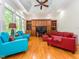 Inviting living room featuring hardwood floors, built-in shelving, and a unique ceiling mural with bright furniture at 540 Vista Del Lago Ln, Wake Forest, NC 27587