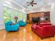 Bright living room featuring a tray ceiling, large windows, hardwood floors, and comfortable seating at 540 Vista Del Lago Ln, Wake Forest, NC 27587