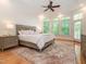 Bright main bedroom with hardwood floors, tray ceiling, ceiling fan, and a bay window for natural light at 540 Vista Del Lago Ln, Wake Forest, NC 27587