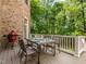Brick home with an outdoor patio featuring a dining table and chairs on a sunny day at 540 Vista Del Lago Ln, Wake Forest, NC 27587