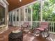 Inviting screened porch with rocking chairs overlooking a beautifully landscaped backyard at 540 Vista Del Lago Ln, Wake Forest, NC 27587