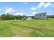 Spacious backyard featuring lush green grass and a view of the home's exterior at 60 Lismore St, Sanford, NC 27330