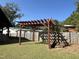 Spacious backyard with a wooden pergola and a well-maintained lawn at 603 Hugo St, Durham, NC 27704