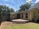 A spacious wood backyard deck is attached to this home with multiple tall windows overlooking it at 603 Hugo St, Durham, NC 27704