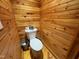 Cozy bathroom featuring a wood-paneled wall and floor with a standard toilet at 603 Hugo St, Durham, NC 27704