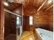 Wood paneled bathroom featuring walk-in shower and large tub at 603 Hugo St, Durham, NC 27704