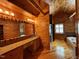 Rustic bathroom featuring wood walls and floors, double vanity, and large bathtub at 603 Hugo St, Durham, NC 27704