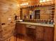 Wood-paneled bathroom with a vanity, large mirror, sink, and wood cabinetry at 603 Hugo St, Durham, NC 27704