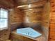 Wood paneled bathroom featuring large jacuzzi tub at 603 Hugo St, Durham, NC 27704