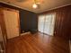 This room boasts hardwood floors, wood paneling, and access to a sliding glass door at 603 Hugo St, Durham, NC 27704