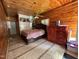Wood-paneled bedroom featuring tile floors, ceiling fan, large bed, and built-in closet at 603 Hugo St, Durham, NC 27704