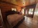 Wood-paneled bedroom with tile floors, fan, big bed, and natural light at 603 Hugo St, Durham, NC 27704