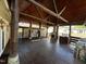 The huge covered deck has wood ceilings and stone pillars with a built-in fireplace and outdoor kitchen at 603 Hugo St, Durham, NC 27704