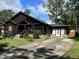 Log cabin home with a long driveway, showcasing its rustic charm and curb appeal at 603 Hugo St, Durham, NC 27704