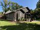 Side view of a log cabin home showing the well-manicured lawn and the house's unique architecture at 603 Hugo St, Durham, NC 27704