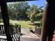 Front Porch overlooking green lawn and tree-lined street from covered wooden porch with wood railings and stone steps at 603 Hugo St, Durham, NC 27704