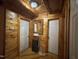 Wood-paneled hallway with white doors, wooden floors, and decorative lighting at 603 Hugo St, Durham, NC 27704
