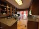 Galley kitchen featuring granite counters, stainless steel appliances, and classic wood cabinets at 603 Hugo St, Durham, NC 27704