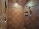 Modern shower stall featuring brown tiles, decorative trim, and a built-in shelf at 603 Hugo St, Durham, NC 27704