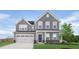 Charming two-story home featuring a well-manicured lawn and attached two-car garage at 61 Lismore St, Sanford, NC 27330