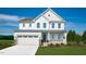 Charming two-story home with a covered front porch, manicured lawn, and attached two-car garage at 62 Lismore St, Sanford, NC 27330