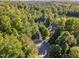 Expansive aerial view of lush, green neighborhood featuring beautiful homes nestled among mature trees and a cul-de-sac at 66 Sweet Meadow Ln, Pittsboro, NC 27312