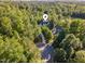 Wonderful aerial view highlighting the property's private driveway nestled amongst mature trees at 66 Sweet Meadow Ln, Pittsboro, NC 27312