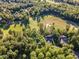Picturesque aerial view overlooking verdant golf course near luxury homes, surrounded by dense, mature trees at 66 Sweet Meadow Ln, Pittsboro, NC 27312