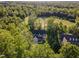 Aerial view of a home nestled among lush green trees and a golf course at 66 Sweet Meadow Ln, Pittsboro, NC 27312