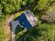 Birds eye view of home and driveway, surrounded by trees and greenery at 66 Sweet Meadow Ln, Pittsboro, NC 27312