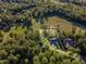 Stunning aerial view showcasing the property's location near a golf course and lush surrounding trees at 66 Sweet Meadow Ln, Pittsboro, NC 27312