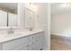 Bright bathroom featuring a double vanity with white cabinets and quartz countertops at 66 Sweet Meadow Ln, Pittsboro, NC 27312