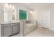 Luxurious bathroom featuring a soaking tub and double vanity with tile floors at 66 Sweet Meadow Ln, Pittsboro, NC 27312